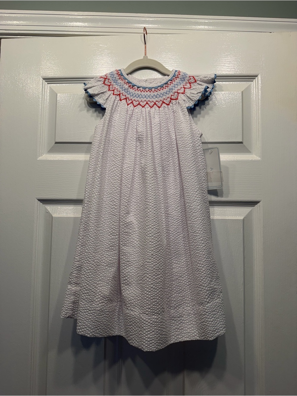 Petit Ami White Seersucker Dress with Red and Blue Smocking
